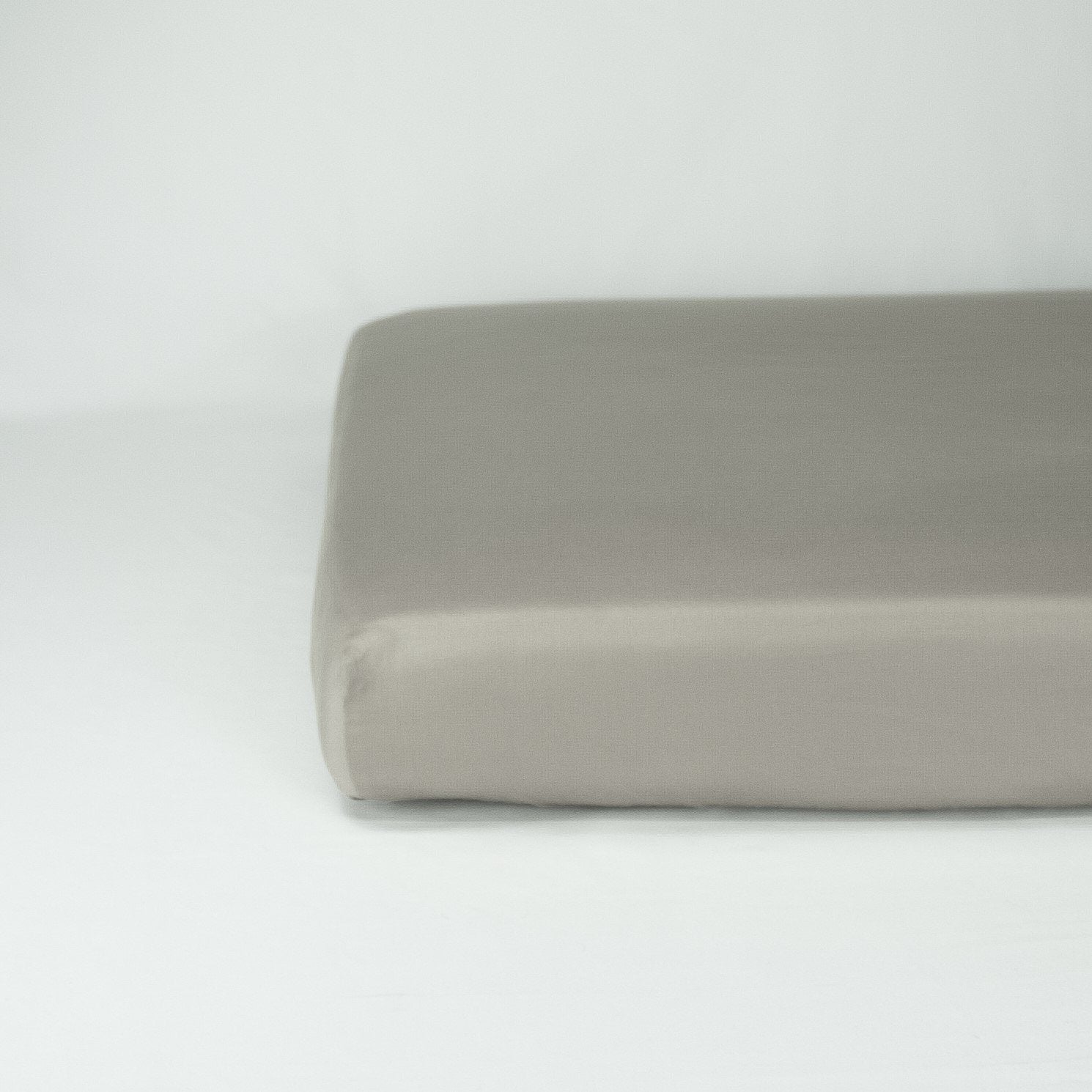 End of mattress with organic cotton fitted cot sheet in sleet grey
